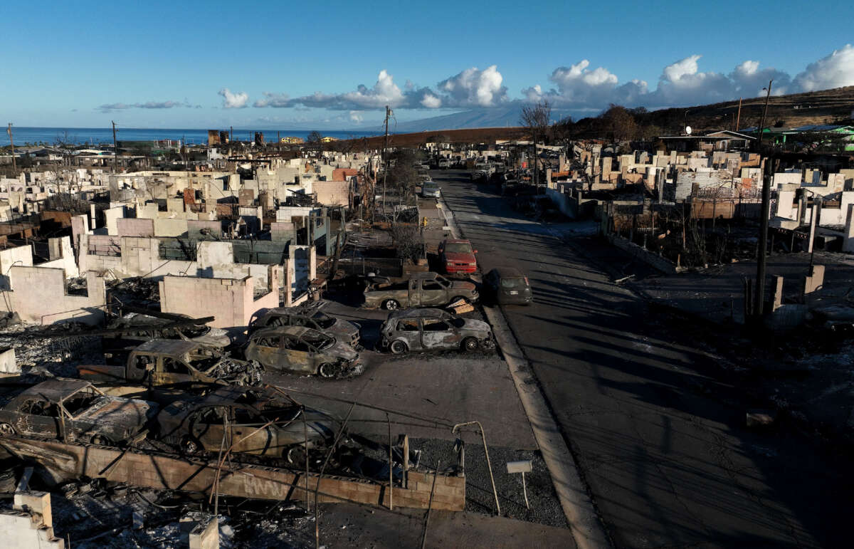 In an aerial view, burned cars and homes are seen in a neighborhood that was destroyed by a wildfire on August 18, 2023, in Lahaina, Hawaii.