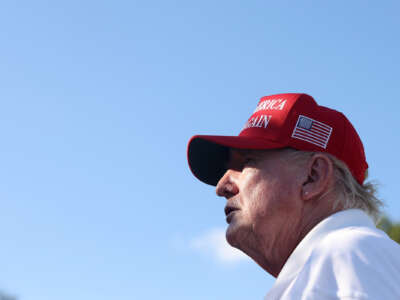 Former President Donald Trump signs autographs hits his shot from the 16th tee during day three of the LIV Golf Invitational Bedminster at Trump National Golf Club on August 13, 2023 in Bedminster, New Jersey.