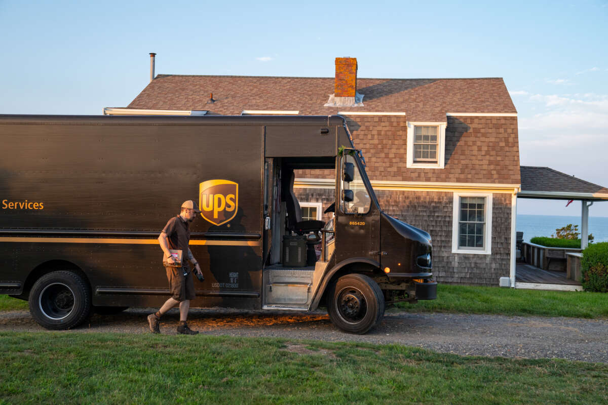 A United Parcel Service driver makes a delivery along the coast of Cape Cod on July 24, 2023, in Orleans, Massachusetts.