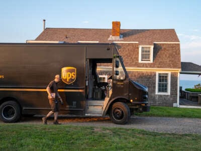 A United Parcel Service driver makes a delivery along the coast of Cape Cod on July 24, 2023, in Orleans, Massachusetts.