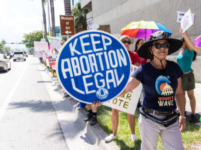 An abortion rights activist holds a sign that says "Keep Abortion Legal" at a protest in support of abortion access on July 13, 2022, in Fort Lauderdale, Florida.