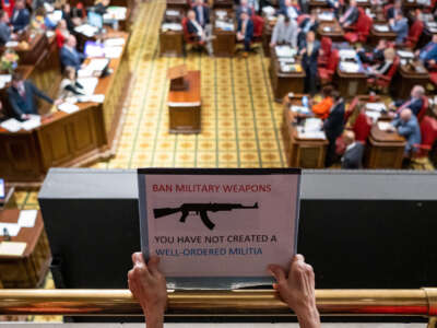 A demonstrator holds a sign during a rally for gun reform at the Tennessee State Capitol building in Nashville, Tennessee, on April 17, 2023.