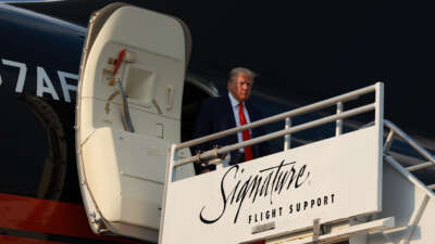 Former President Donald Trump arrives at Atlanta Hartsfield-Jackson International Airport on August 24, 2023, in Atlanta, Georgia.