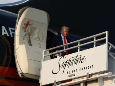 Former President Donald Trump arrives at Atlanta Hartsfield-Jackson International Airport on August 24, 2023, in Atlanta, Georgia.