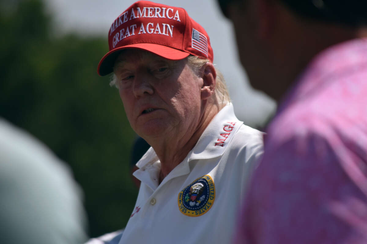 Former President Donald Trump plays golf at the driving range at LIV Golf Bedminster 2023 Event in Bedminster, New Jersey, on August 9, 2023.