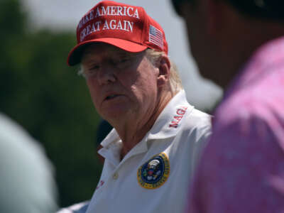 Former President Donald Trump plays golf at the driving range at LIV Golf Bedminster 2023 Event in Bedminster, New Jersey, on August 9, 2023.