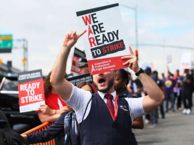 American Airlines flight attendants picket at Terminal B at LaGuardia Airport on August 30, 2023, in the Queens borough of New York City.