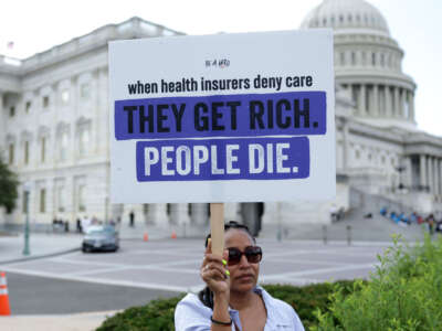An advocate holds a sign during a news conference on Medicare Advantage plans in front of the U.S. Capitol on July 25, 2023, in Washington, D.C.