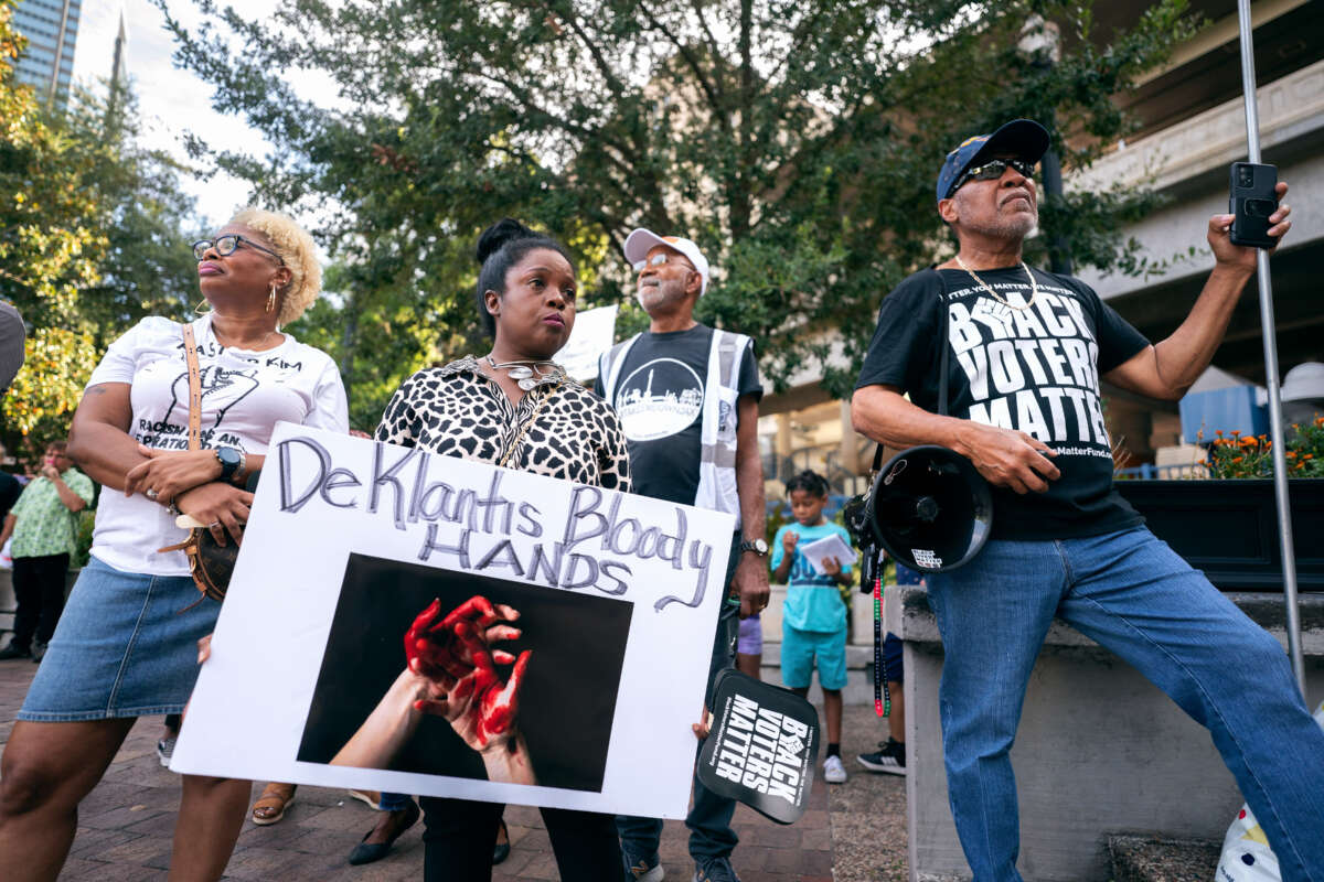 Demonstrators listen to a speaker during a rally against white supremacy at James Weldon Johnson Park August 28, 2023, in Jacksonville, Florida.