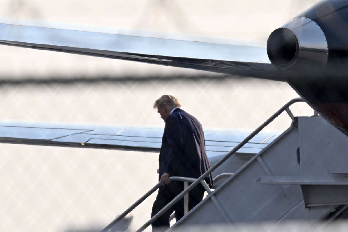 Former President Donald Trump steps off his plane Trump Force One upon arrival at Atlanta Hartsfield-Jackson International Airport on his way to the Fulton County Jail in Atlanta, Georgia, on August 24, 2023.