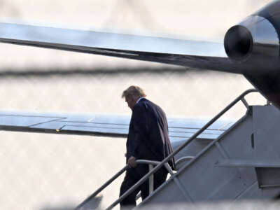 Former President Donald Trump steps off his plane Trump Force One upon arrival at Atlanta Hartsfield-Jackson International Airport on his way to the Fulton County Jail in Atlanta, Georgia, on August 24, 2023.