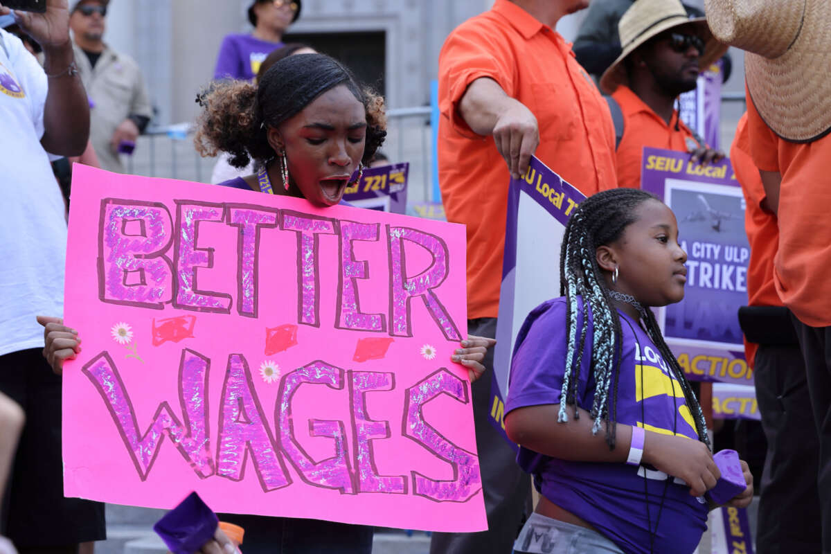 Los Angeles city workers holding placards gather at City Hall during a 24-hour strike over unfair labor practice on August 8, 2023, in Los Angeles, California.