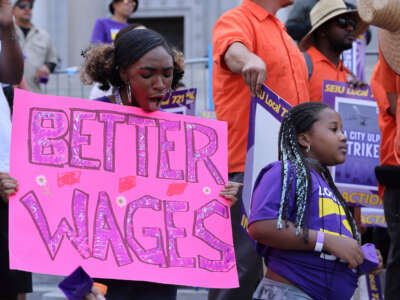 Los Angeles city workers holding placards gather at City Hall during a 24-hour strike over unfair labor practice on August 8, 2023, in Los Angeles, California.