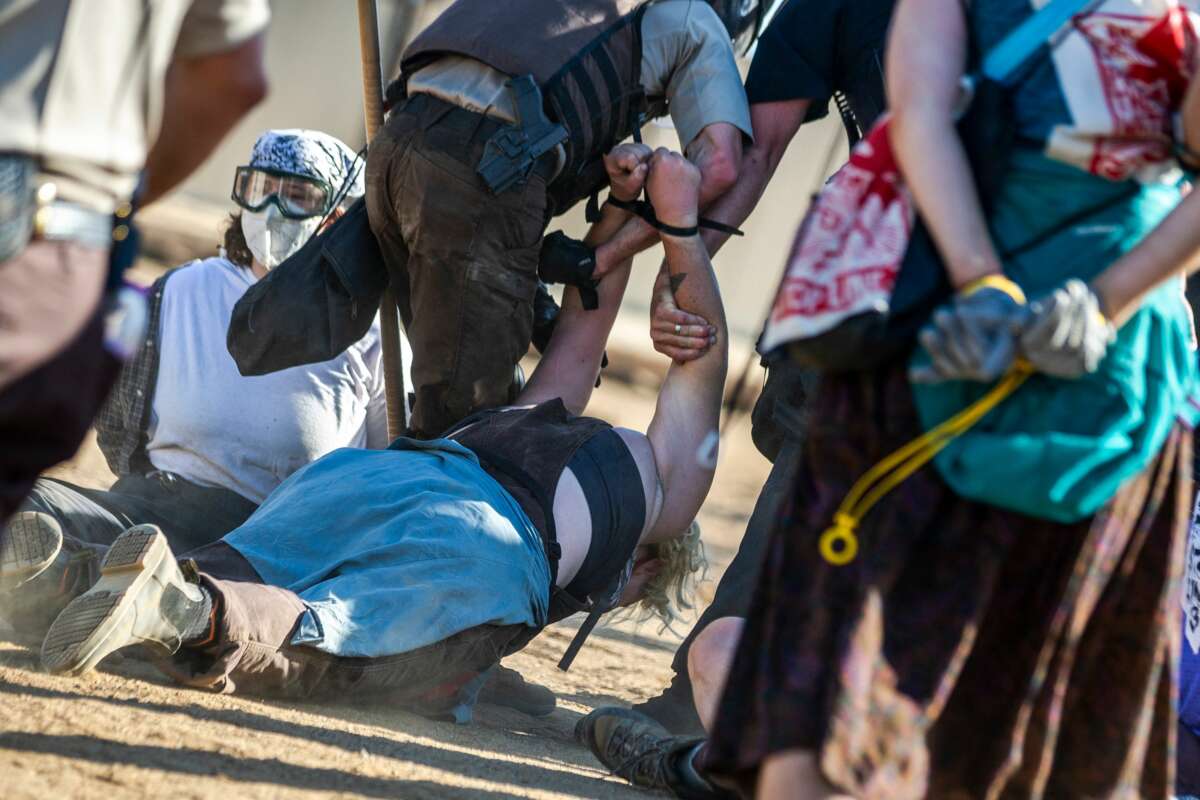 Police in riot gear arrest environmental activists at the Line 3 pipeline pumping station near the Itasca State Park, Minnesota on June 7, 2021.