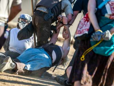 Police in riot gear arrest environmental activists at the Line 3 pipeline pumping station near the Itasca State Park, Minnesota on June 7, 2021.