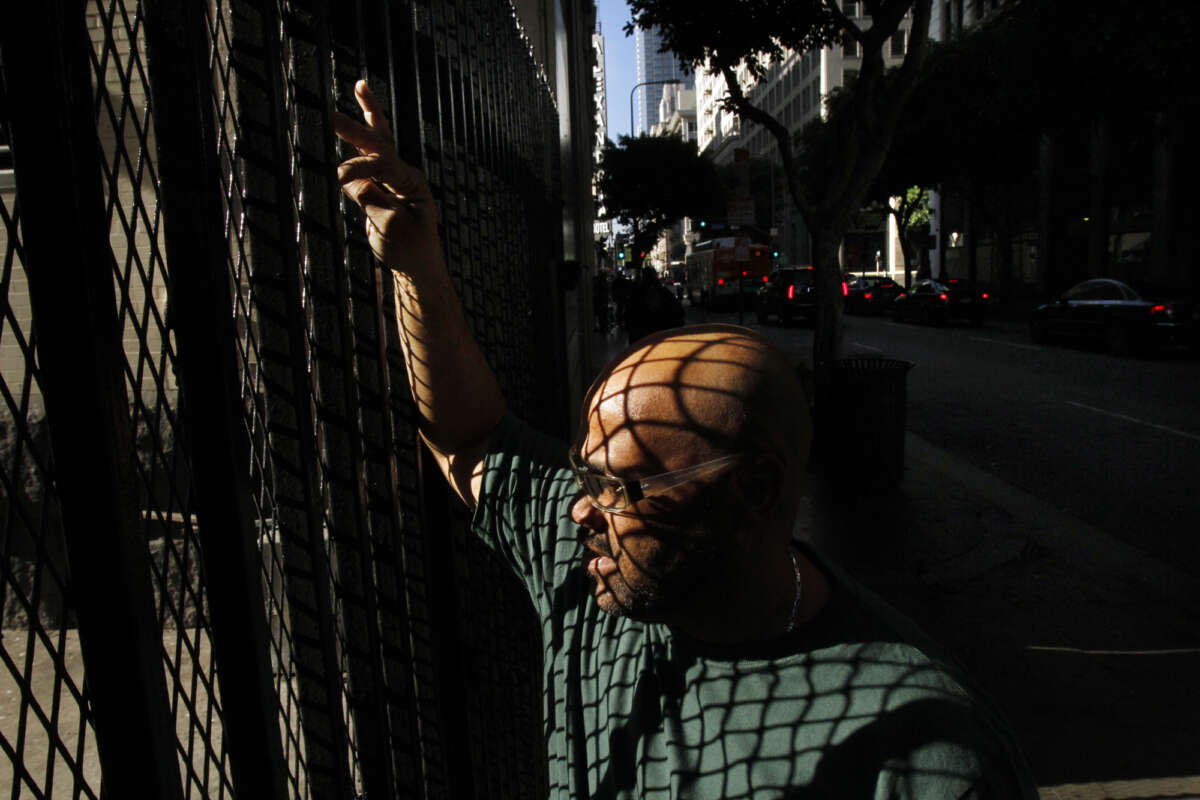 A parole recipient pauses on his way to catch the bus as he looks for work on November 18, 2010, in Los Angeles, California.