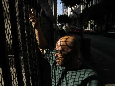 A parole recipient pauses on his way to catch the bus as he looks for work on November 18, 2010, in Los Angeles, California.