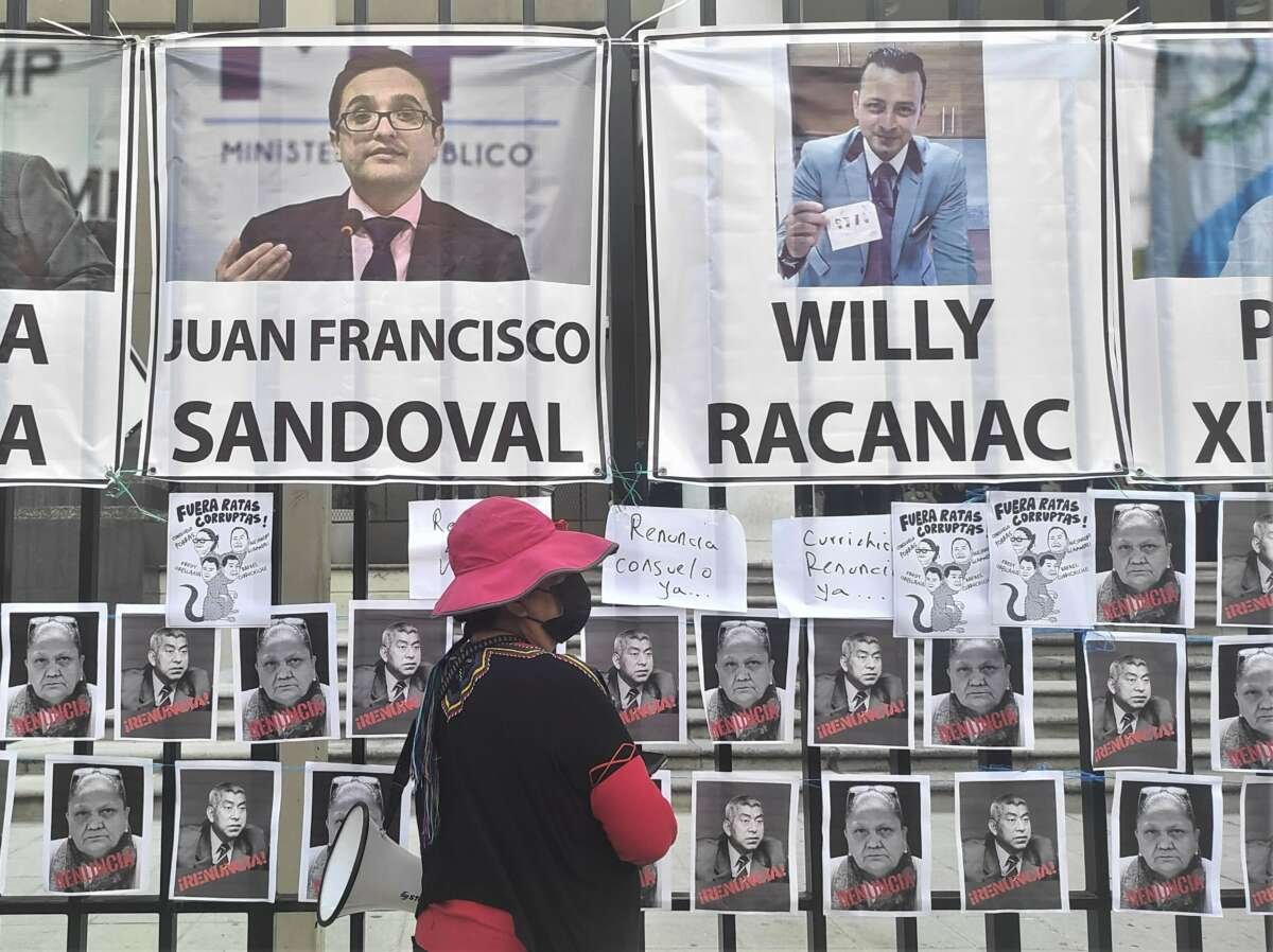 Banners depicting former anti-impunity prosecutors and others persecuted for their anti-corruption efforts hang outside the public prosecutor's office during an August 25 protest in Guatemala City