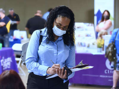 A woman seeking employment attends the 25th annual Central Florida Employment Council Job Fair at the Central Florida Fairgrounds on May 12, 2021.