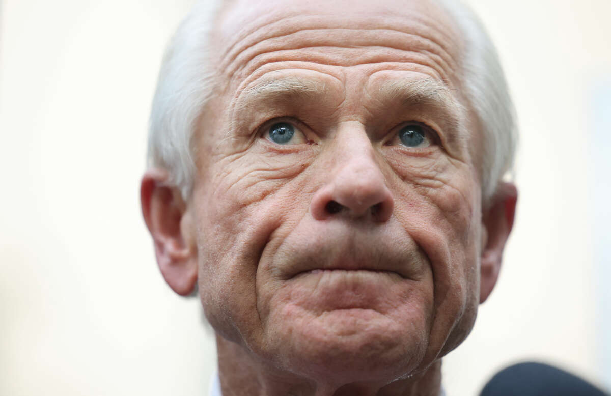Peter Navarro stands against a cloudy sky