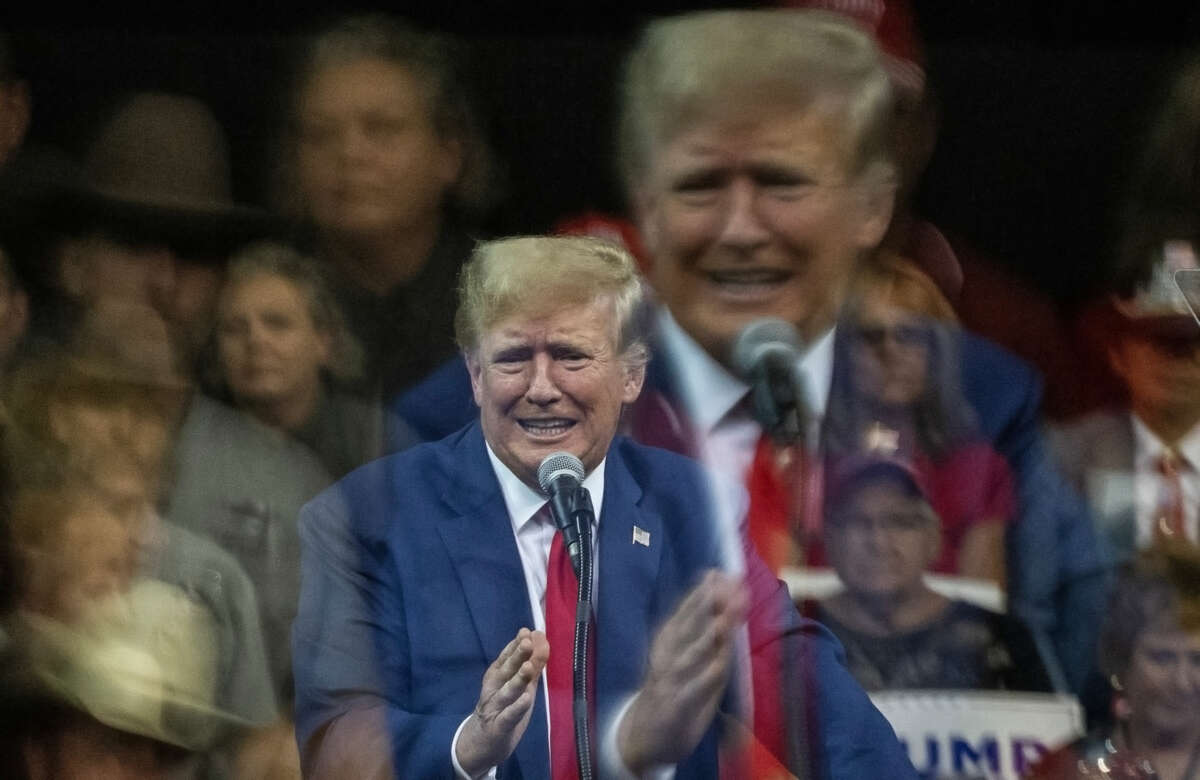 A photo of Donald Trump grimacing, shot in such a way that there's a double exposure of his face