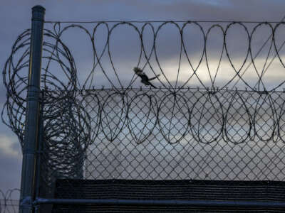 A bird takes flight from the fencing and razor wire that surrounds Clark County Juvenile Detention on June 23, 2021, in Las Vegas, Nevada.