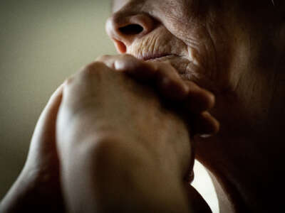 Elderly woman sitting in contemplation