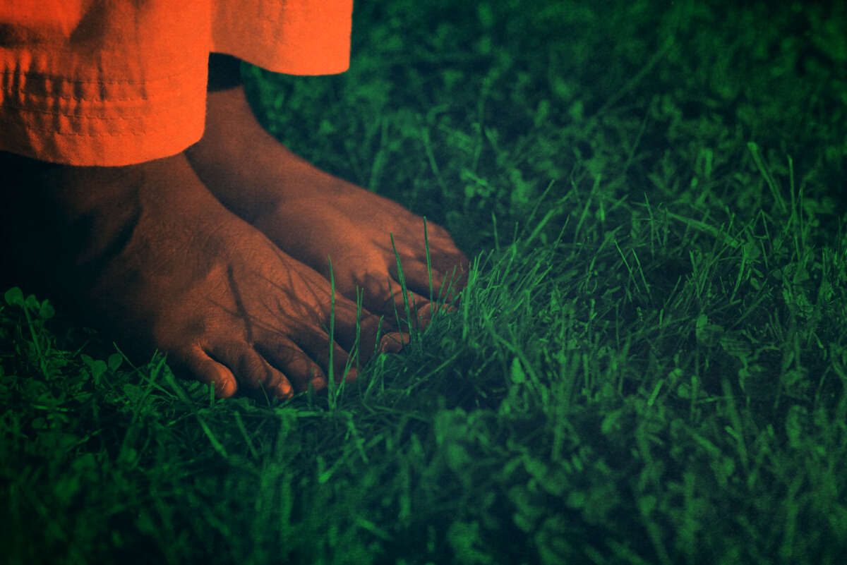 Prisoner's bare feet on grass