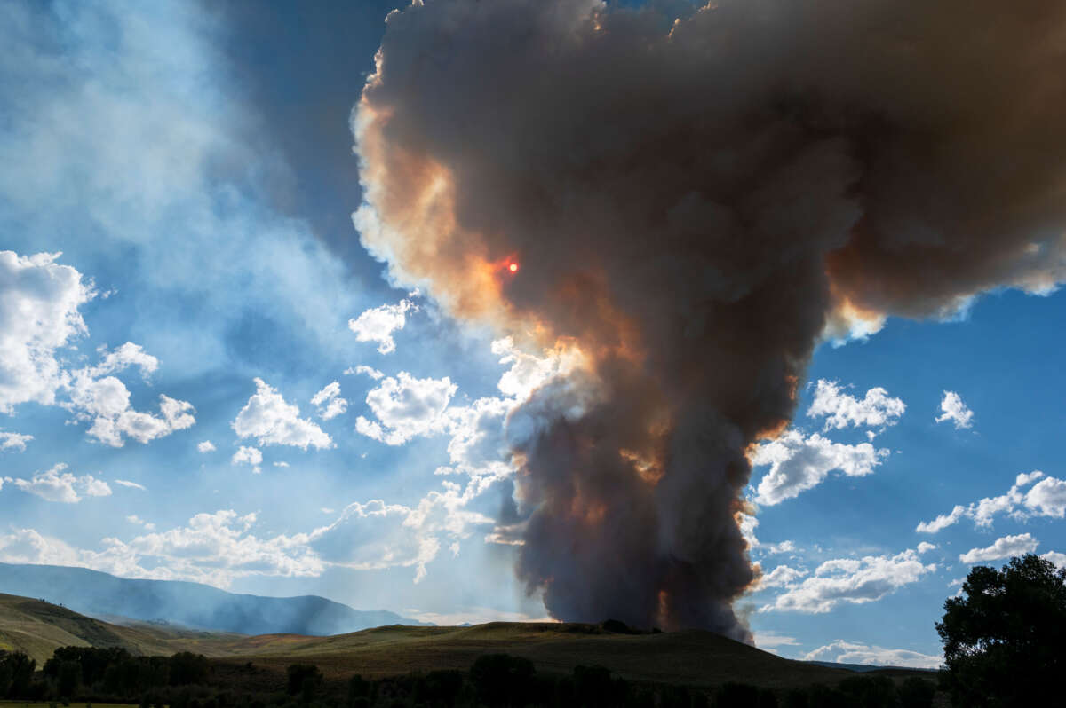 Smoke billows and flames rise from the Lowline Fire on July 26, 2023, near Gunnison, Colorado.