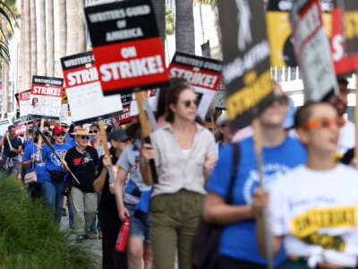 Striking WGA (Writers Guild of America) members picket with striking SAG-AFTRA members outside Netflix studios on September 22, 2023, in Los Angeles, California.