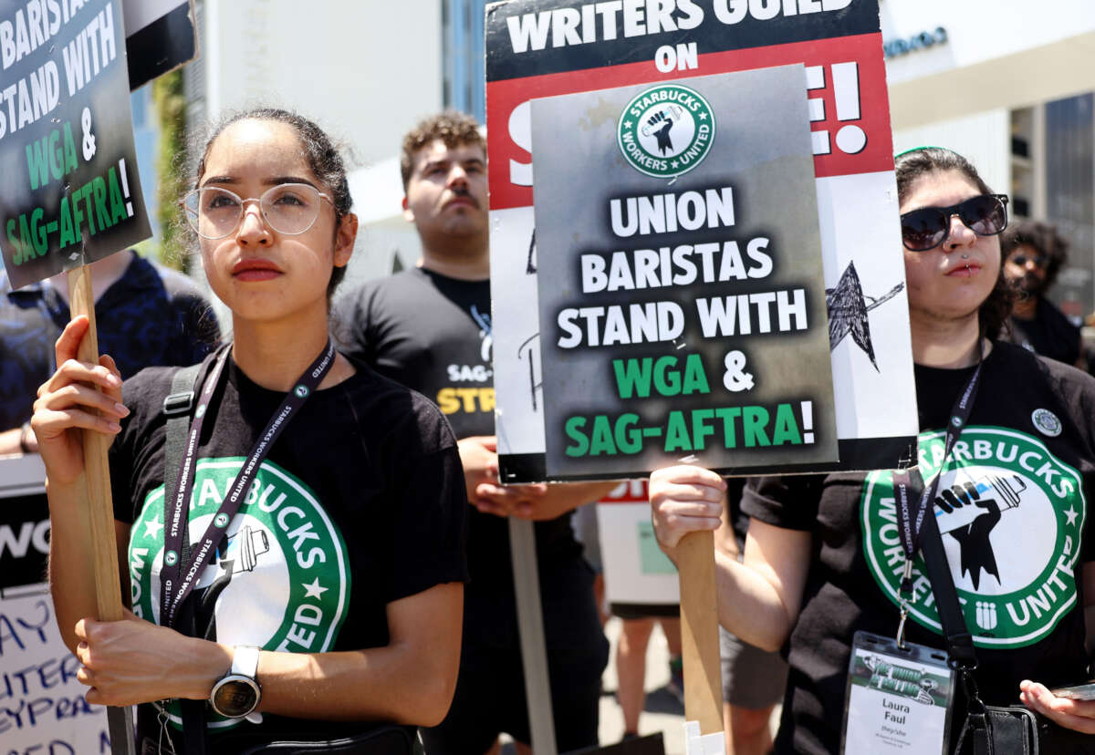 Starbucks workers stand with striking SAG-AFTRA and Writers Guild of America (WGA) members on the picket line in solidarity outside Netflix studios on July 28, 2023, in Los Angeles, California.