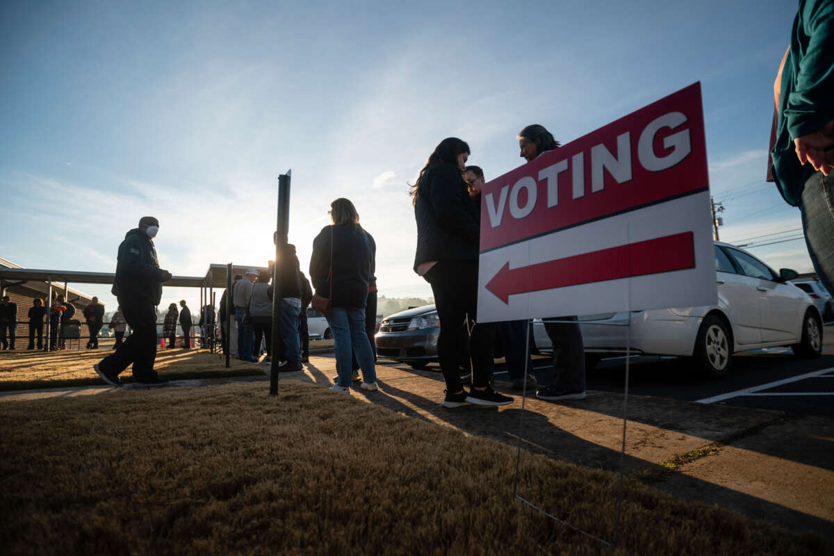 People are seen in line to vote at the sole polling place open for Saturday early voting in Bartow County on November 26, 2022, in Cartersville, Georgia.