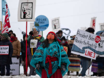 A member of the Kalpulli Yaocenoxtli Aztec cultural group performs a dance during the Line 3 pipeline protest in downtown St. Paul