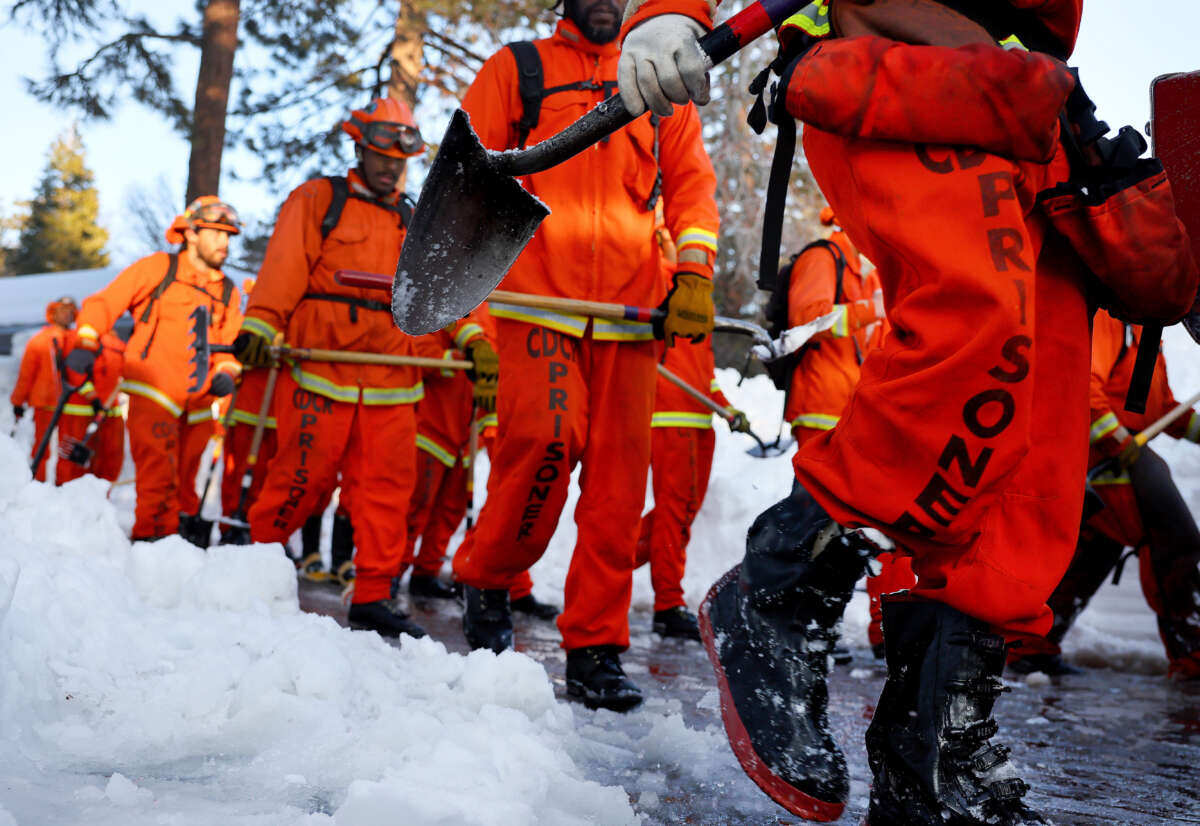 A crew of incarcerated firefighters walk back to their vehicle after shoveling and clearing snow after a series of winter storms in the San Bernardino Mountains in southern California on March 3, 2023, in Crestline, California.