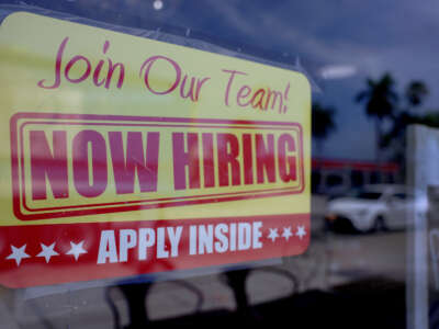 A "Now Hiring" sign posted in the window of a restaurant looking to hire workers on May 5, 2023 in Miami, Florida.