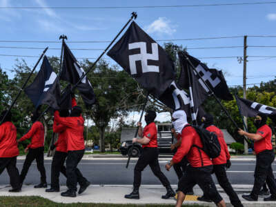 Neo-Nazis march with swastika flags as groups Blood Tribe and Goyim Defense League hold a rally on September 2, 2023, in Orlando, Florida.