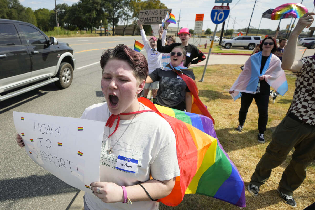 Max Newell, left, joins student demonstrators as they protest against Katy ISD's new transgender policy outside the school district's educational support complex on August 30, 2023 in Katy, Texas.