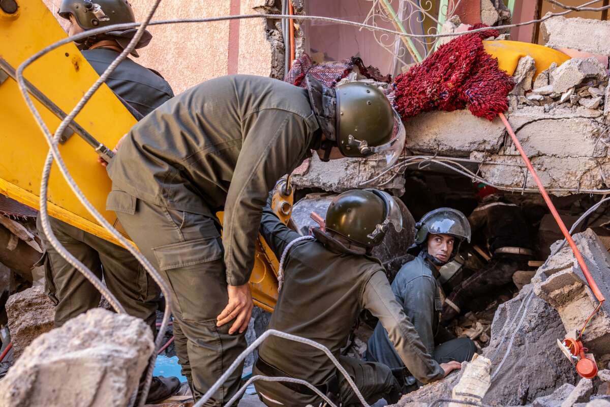 Rescue workers search for survivors in a collapsed house in Moulay Brahim, Morocco, on September 9, 2023.