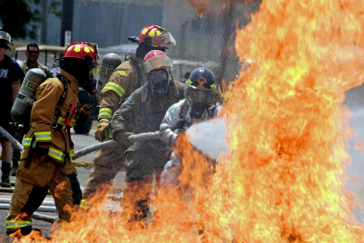 Firefighters from the U.S. 612th Air Base Squadron Fire Department carry out a fire drill exercise with brigades from Guatemala, Panama, El Salvador, Belice, Nicaragua and Honduras, at the United States military base Palmerola, in Comayagua, Honduras, on April 25, 2018.