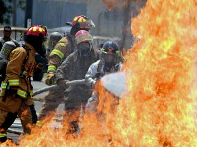 Firefighters from the U.S. 612th Air Base Squadron Fire Department carry out a fire drill exercise with brigades from Guatemala, Panama, El Salvador, Belice, Nicaragua and Honduras, at the United States military base Palmerola, in Comayagua, Honduras, on April 25, 2018.