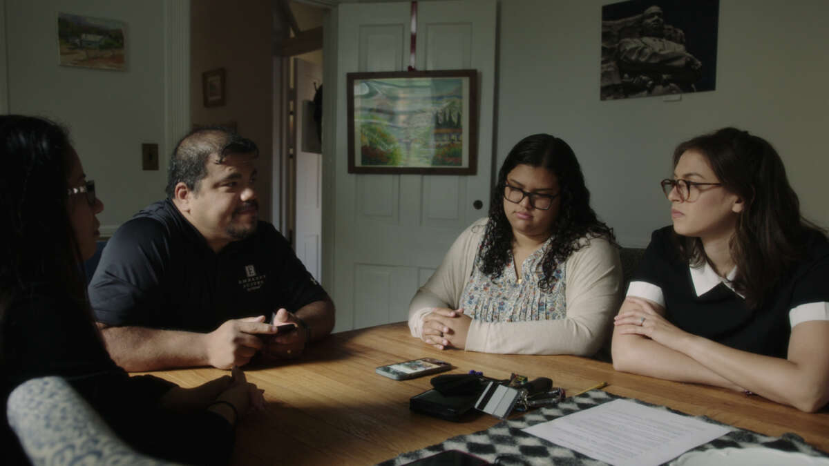 Dyanie Bermeo (second from right) and her parents, Gabe Bermeo and Karla Cardenas, speak with reporter Rachel de Leon (right) in Abingdon, Virginia, in August 2021.