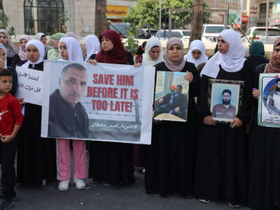Relatives of Palestinians detained in Israeli jails carry pictures of prisoners as they demonstrate to demand their release and in solidarity with the people of the Gaza Strip, in the occupied West Bank city of Ramallah on October 28, 2023.
