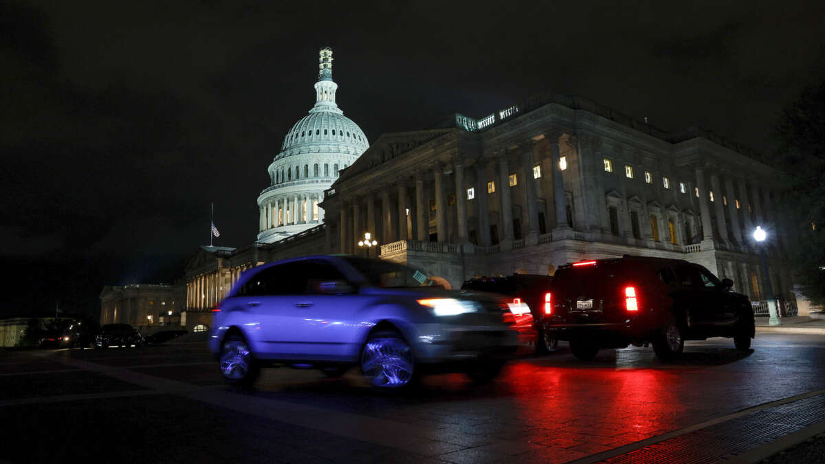 Cars drive past the U.S. Capitol during a vote on a continuing resolution to fund the government on September 30, 2023, in Washington, D.C.