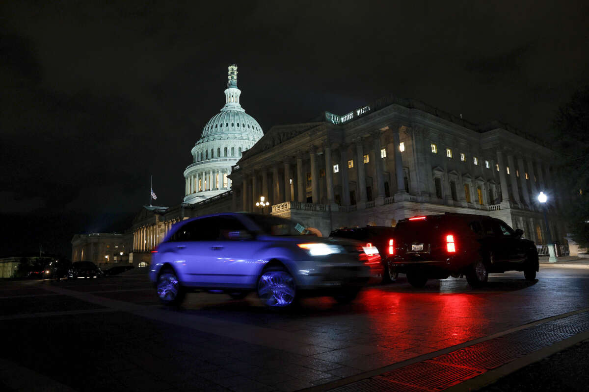 Cars drive past the U.S. Capitol during a vote on a continuing resolution to fund the government on September 30, 2023, in Washington, D.C.