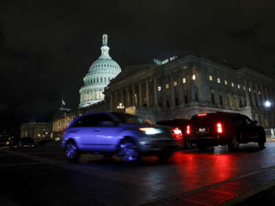 Cars drive past the U.S. Capitol during a vote on a continuing resolution to fund the government on September 30, 2023, in Washington, D.C.