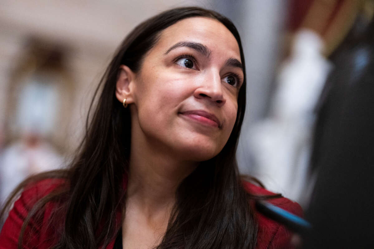 Rep. Alexandria Ocasio-Cortez talks with reporters in the U.S. Capitol's Statuary Hall on January 12, 2023.