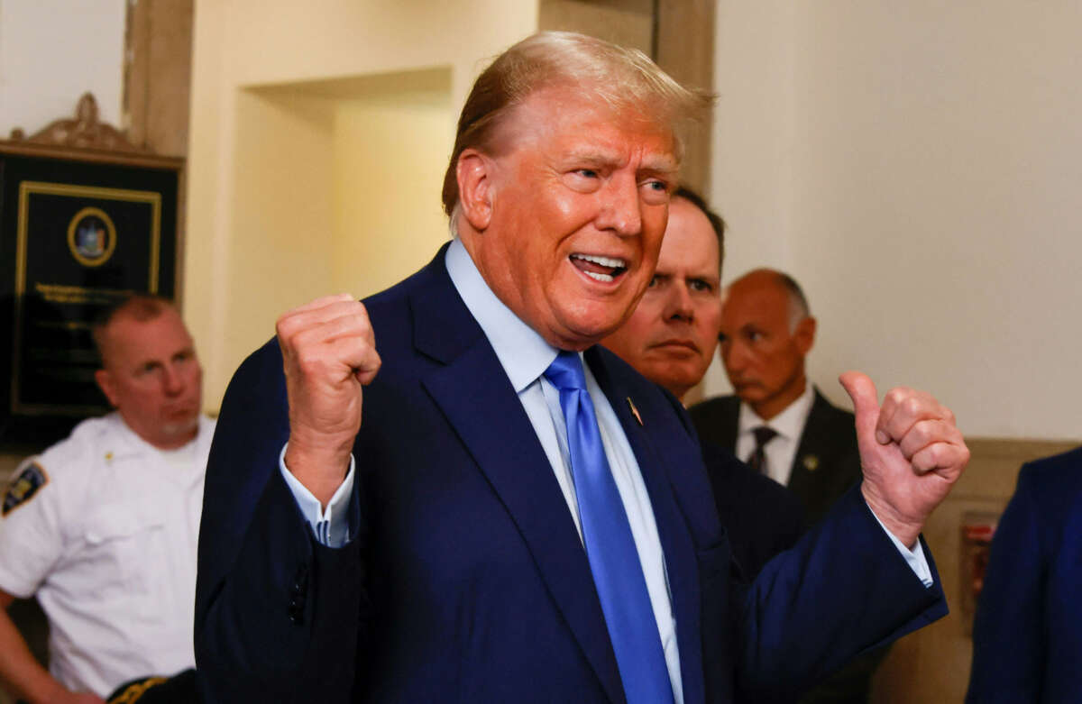 Former President Donald Trump talks to members of the media outside the court room at the New York State Supreme Court on the first day of his civil fraud trial in New York City on October 2, 2023.