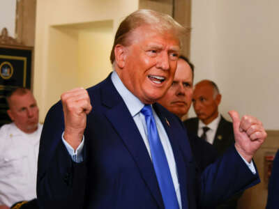 Former President Donald Trump talks to members of the media outside the court room at the New York State Supreme Court on the first day of his civil fraud trial in New York City on October 2, 2023.