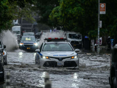Vehicles make their way through floodwater in Brooklyn, New York, on September 29, 2023.