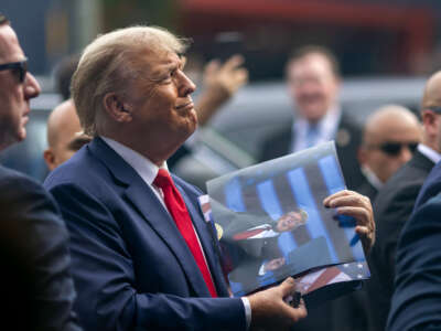 Former President Donald Trump signs autographs outside a Carvel Ice Cream and Cake Shop during the California GOP convention on September 29, 2023, in Los Angeles, California.